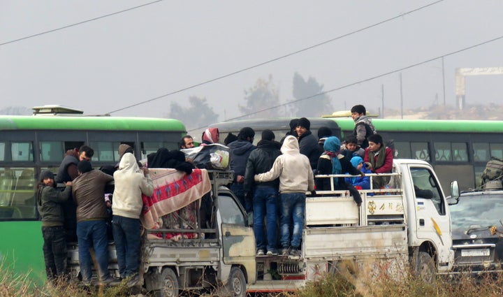 Syrians are evacuated from a rebel-held area of Aleppo on December 16