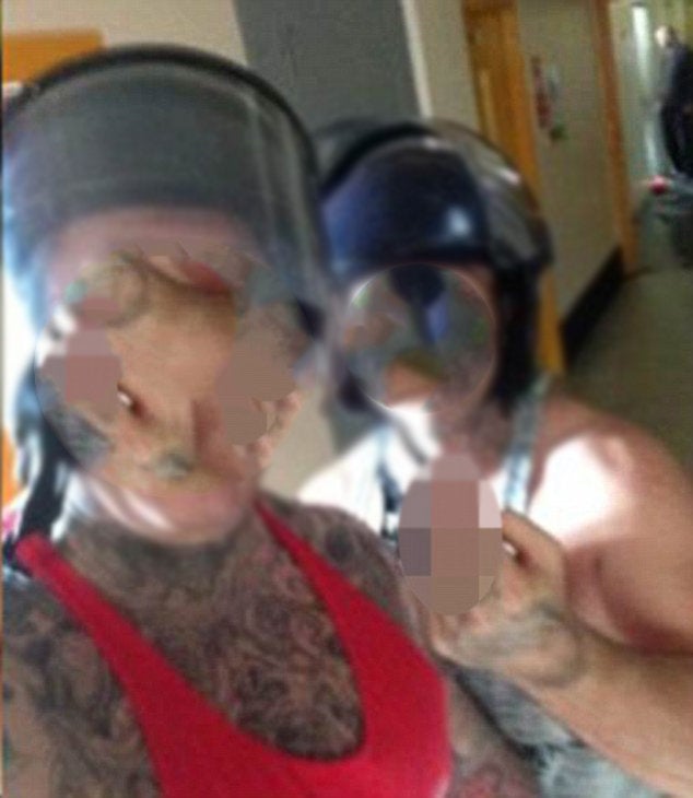 Two prisoners were pictured grinning in officer issue riot gear in an image on social media