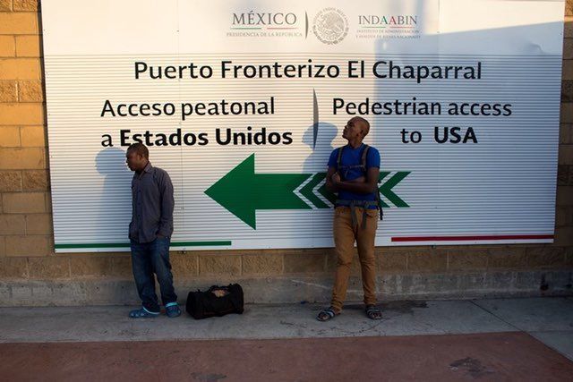 Haitian migrants seeking asylum in the United States wait at El Chaparral border crossing in the Mexican border city of Tijuana, Oct. 7, 2016.