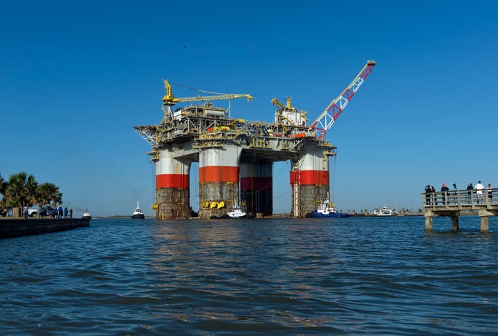 Tug boats transport a drilling and production platform to the Gulf of Mexico from Ingleside, Texas, in 2013.