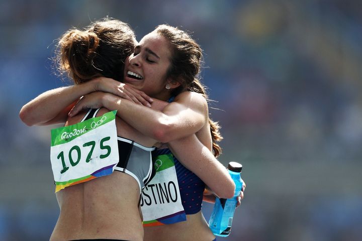 Abbey D'Agostino of the United States, right, hugs Nikki Hamblin of New Zealand, left, after the second heat of the women's 5000m during the 2016 Olympic Games, Aug. 16, 2016.