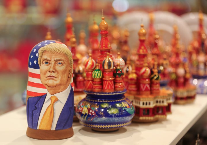 A martyoshka doll showing Donald Trump, U.S. president elect, sits beside painted wooden models of St. Basil's cathedral in a souvenir store in Moscow, Russia, on Wednesday, November 9, 2016.