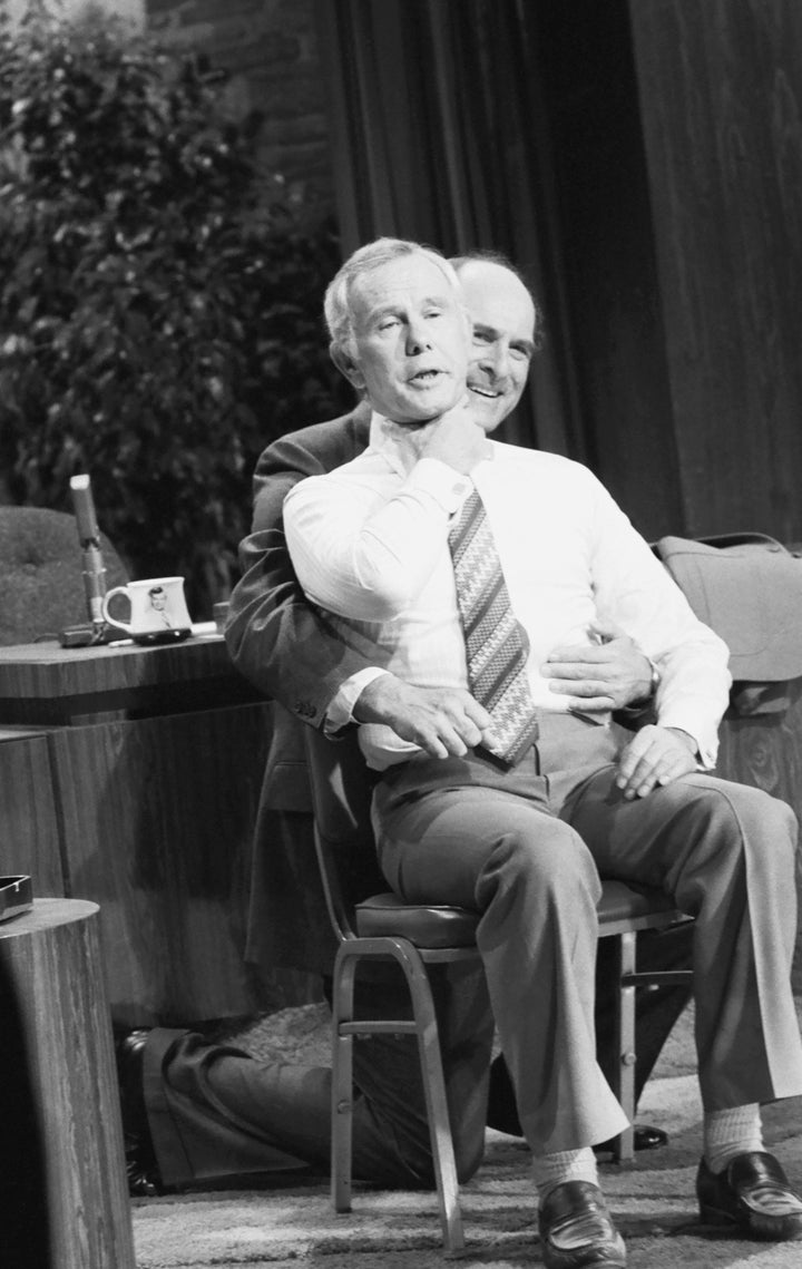 Dr. Henry heimlich demonstrates the heimlich maneuver on host Johnny Carson on April 4, 1979