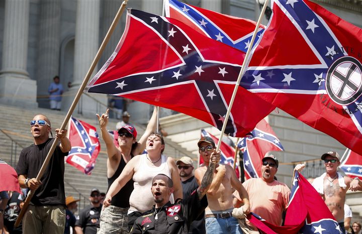 Members of the Ku Klux Klan yell as they fly Confederate flags during a rally at the statehouse in Columbia, South Carolina July 18, 2015.