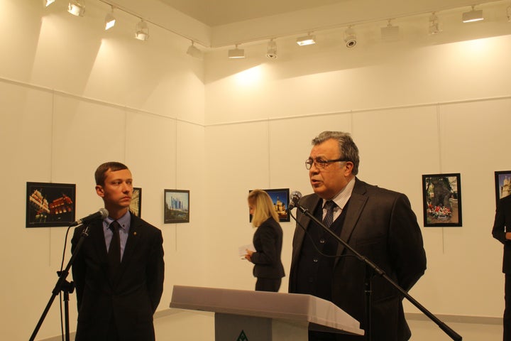 Russian Ambassador to Turkey, Andrei Karlov (R) gives a speech as he visits an art fair at Modern Art Center in Ankara, Turkey on December 19, 2016.