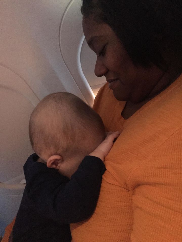 The woman next to Hughes offered to hold his son while he took a quick nap. 