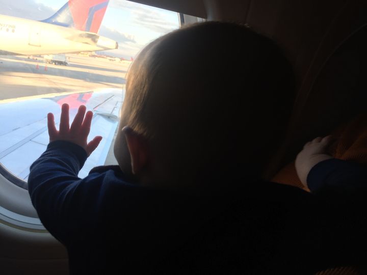 Evan Hughes was having "one of the worst days in a long time" during a hectic travel day with his 8-month-old. Then, he got help from a kind stranger. 