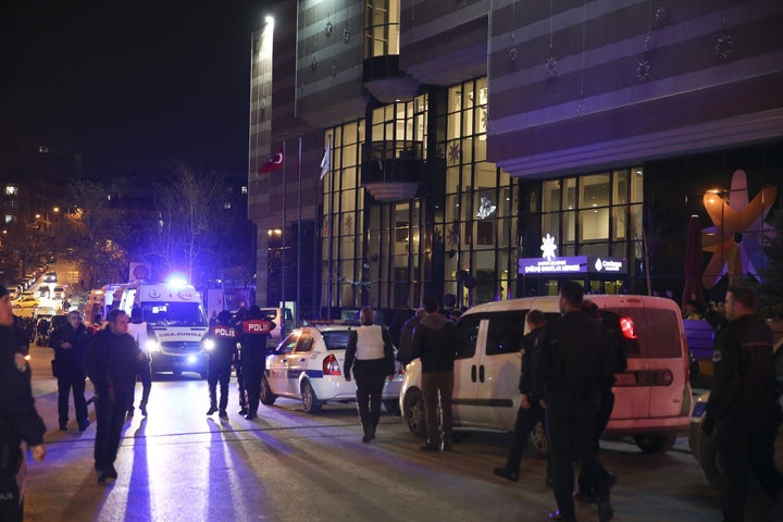 Turkish police take security measures in front of the building where the shooting happened