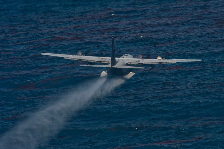 A U.S. Air Force C-130 aircraft drops an oil dispersing chemical as part of the Deepwater Horizon oil spill response effort in the Gulf of Mexico, U.S., on Wednesday, May 5, 2010.