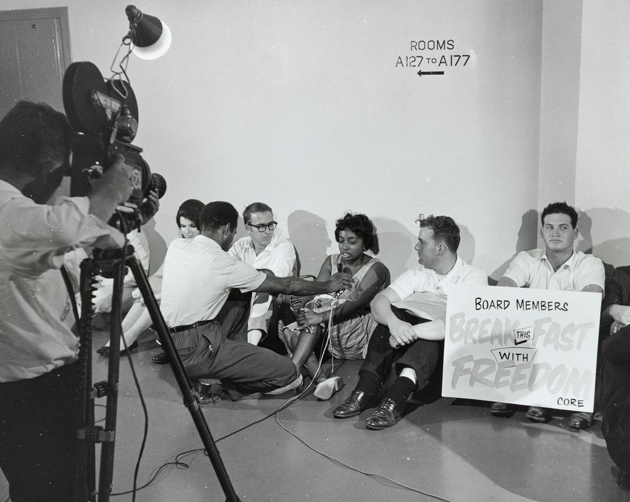 News media interviewing CORE activists waging a sit-in and hunger strike outside the Los Angeles Board of Education offices to raise awareness of segregation and inequality in the public schools.