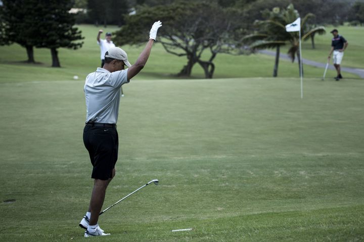 US President Barack Obama reacts on the 18th hole of the Mid-Pacific Country Club's golf course December 21, 2015 in Kailua, Hawaii.