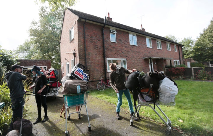 Squatters remove their belongings during an eviction from a home next to a housing estate in north London, Britain, September
