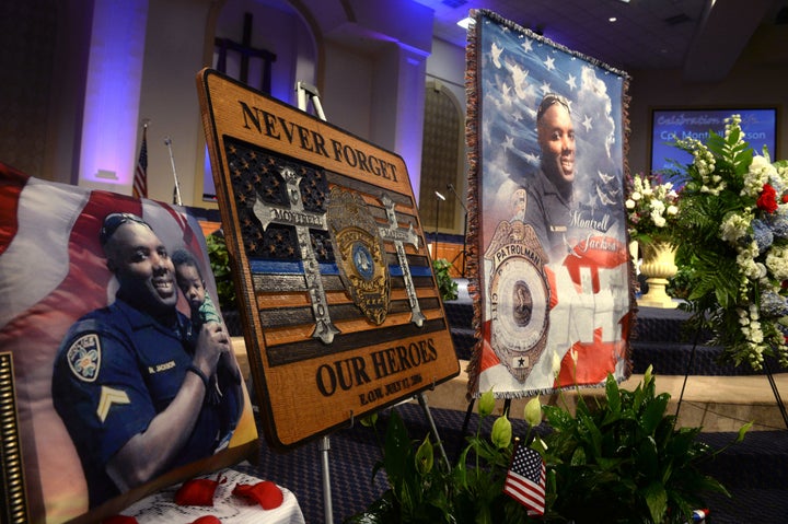 BATON ROUGE, LA - JULY 25: Signs and photos are displayed during the funeral of Baton Rouge police corporal Montrell Jackson at the Living Faith Christian Center - July 25, 2016 in Baton Rouge, Louisiana.