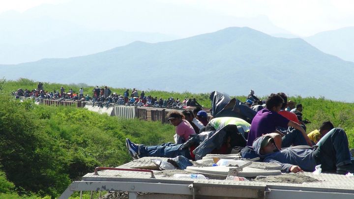 People hoping to reach the U.S. ride atop the wagon of a freight train, known as La Bestia (The Beast) in Mexico. 