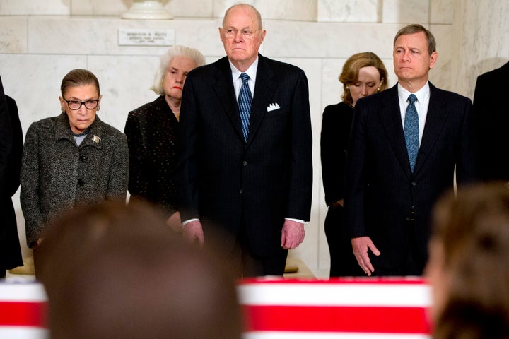 Supreme Court Justices Ruth Bader Ginsburg, left, Anthony M. Kennedy, and Chief Justice John G. Roberts, Jr., attend a private ceremony in the Great Hall of the Supreme Court where late Supreme Court Justice Antonin Scalia lies in repose in Washington on February 19, 2016 in Washington, DC. Justice Scalia will lie in repose in the Great Hall of the high court where visitors will pay their respects.