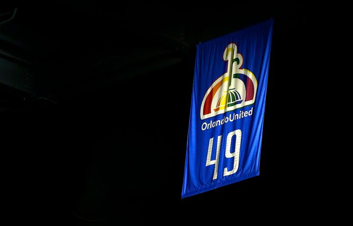 Orlando Magic raise a banner displaying the number 49 to commemorate the lives lost in the Pulse nightclub shooting before the game against the Miami Heat at Amway Center.
