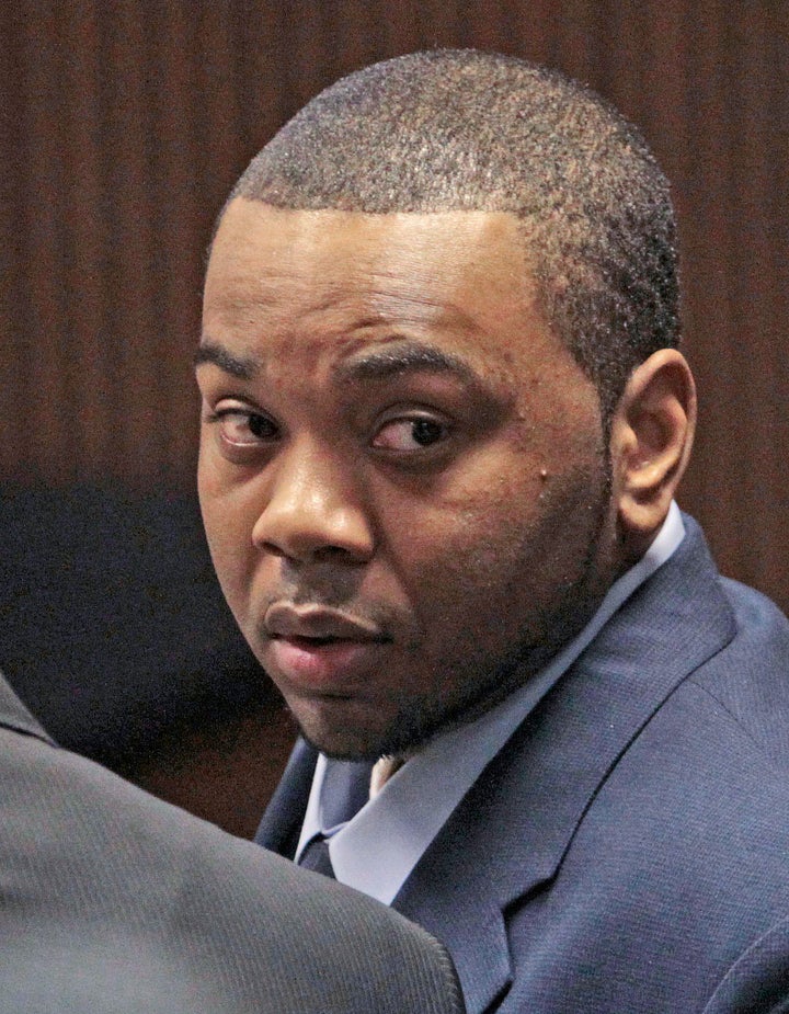 In this file photo taken Nov. 12, 2010, murder defendant Courtney Lockhart looks towards his mother during opening statements