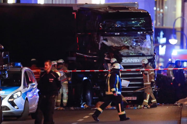 A firefighter walks in front of a truck at the site of an accident at a Christmas market on Breitscheidplatz square near the fashionable Kurfuerstendamm avenue in the west of Berlin, Germany.