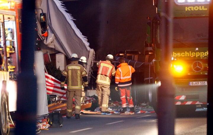 Rescue workers stand at the scene.