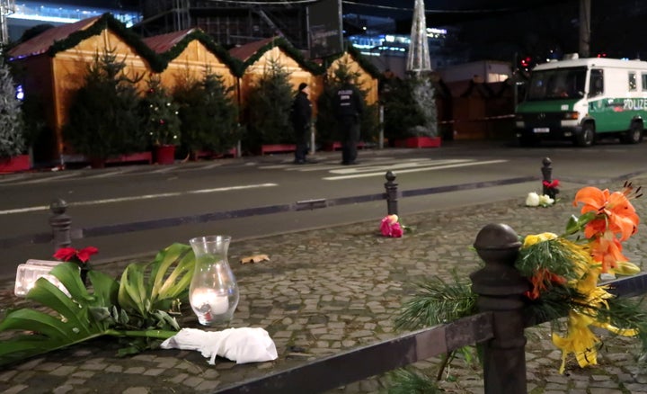 A candle and flowers are seen near the site where a truck ploughed through a crowd.