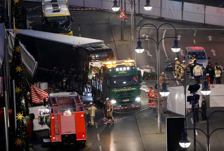 A tow truck operates at the scene where a truck ploughed through a crowd at a Christmas market on Breitscheidplatz square.