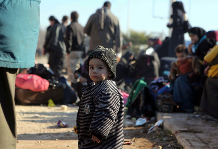 A young Syrian child evacuated from Aleppo during the ceasefire arrives at a refugee camp in Rashidin, near Idlib on December 19.