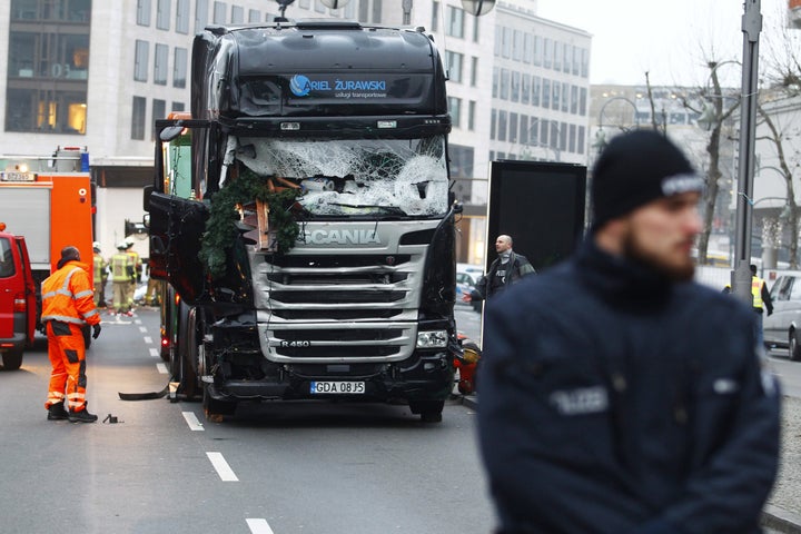 Security and rescue workers tend to the area after a lorry truck ploughed through a Christmas market on December 20, 2016 in Berlin, Germany.