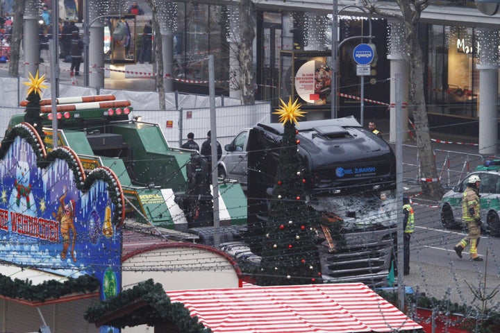 Security and rescue workers tend to the area after a lorry truck ploughed through a Christmas market on December 20, 2016 in Berlin, Germany.