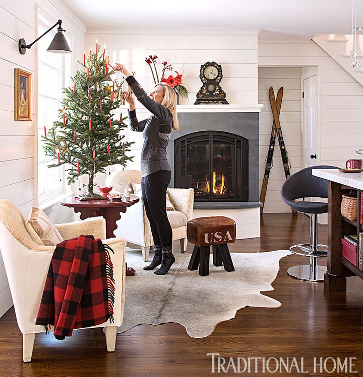 Clean Christmas design with candles on the tree, courtesy of Traditional Home.