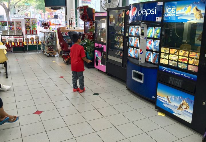 A child considers his food choices at a laundromat