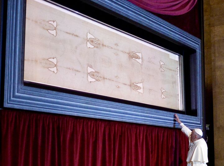 Pope Francis touches the holy Shroud, believed by some Christians to be the burial shroud of Jesus of Nazareth, on June 21, 2015, in Turin's cathedral.