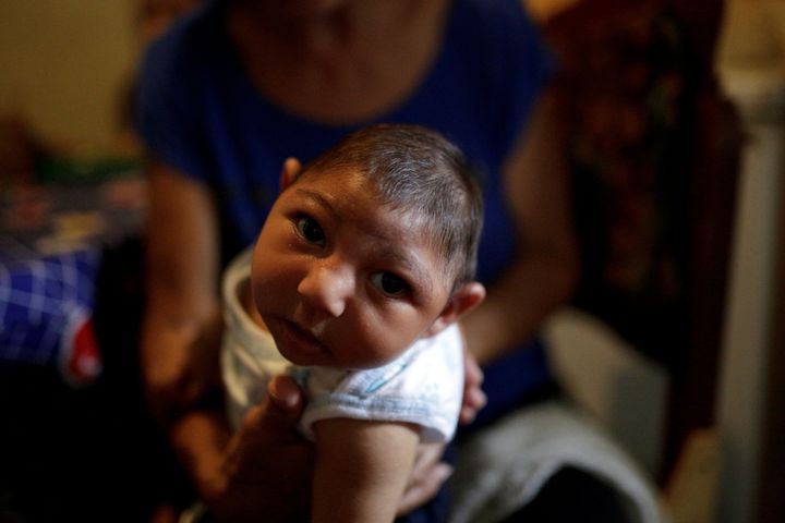 Lisdeth Arguello holds her 3-month-old grandson Jesus, who was born with microcephaly, at their home in Guarenas, Venezuela October 5, 2016. Picture taken October 5, 2016.