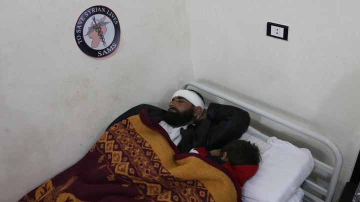 Mohamed*, an evacuated patient, and his son&nbsp;rest at a Syrian American Medical Society facility in Idlib, Syria.