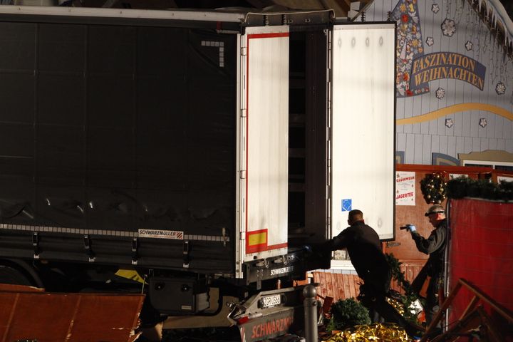 <strong>Security and rescue workers inspect a lorry truck after it was ploughed through a Christmas market.</strong>