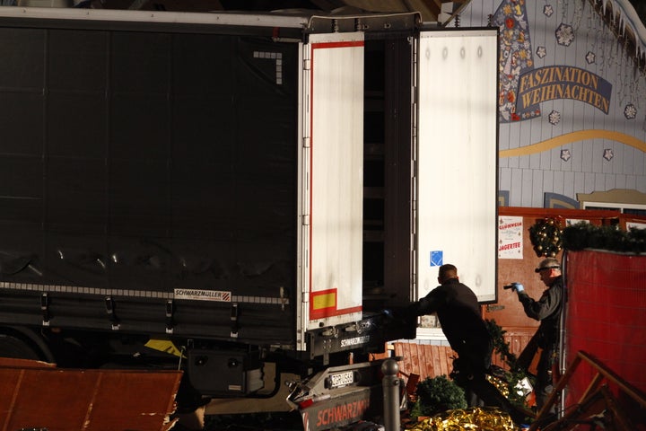 Security and rescue workers inspect a lorry truck after it was ploughed through a Christmas market.