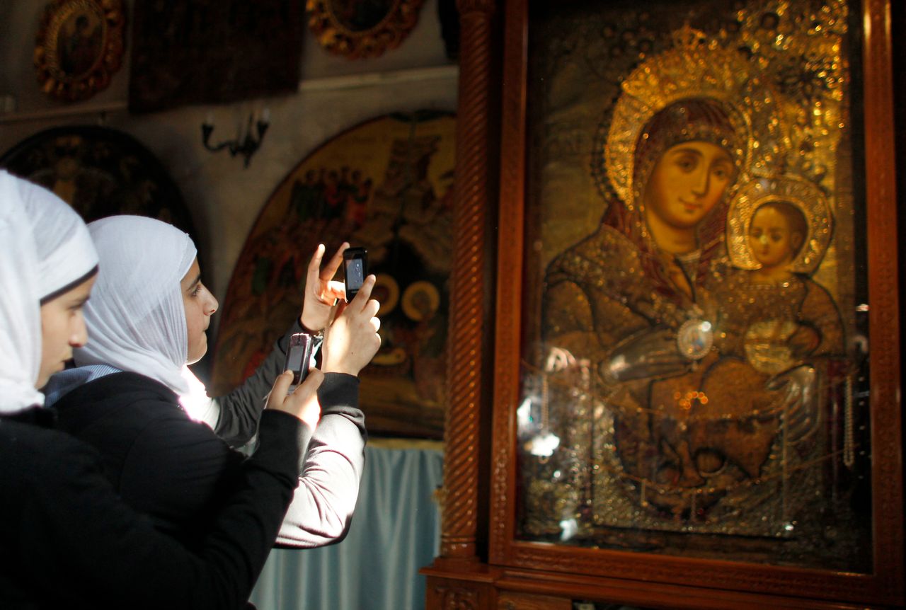 Muslim teenagers take photographs at the Church of the Nativity, the site revered as the birthplace of Jesus, in the West Bank town of Bethlehem.