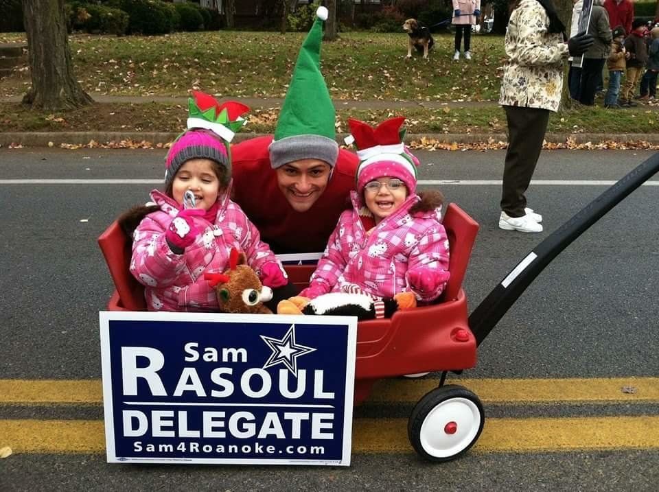 Sam Rasoul poses with his children in holiday costumes.