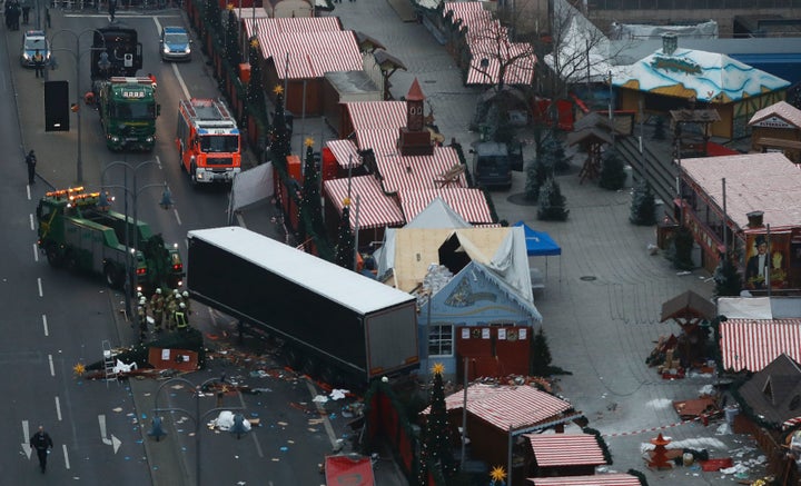 Forensic experts examine the scene around the truck that crashed into a Christmas market