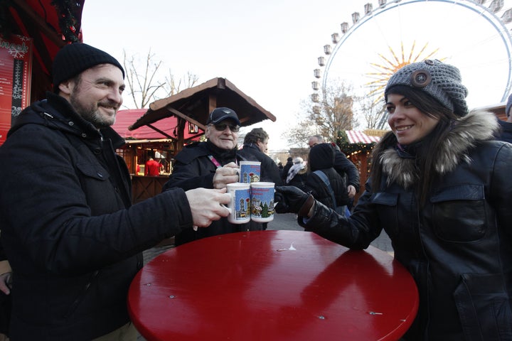 Visitors today toasted with mulled wine in a Christmas market at Alexanderplatz, Berlin