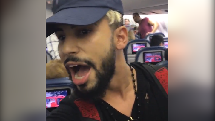 Adam Saleh as he was escorted off the flight.