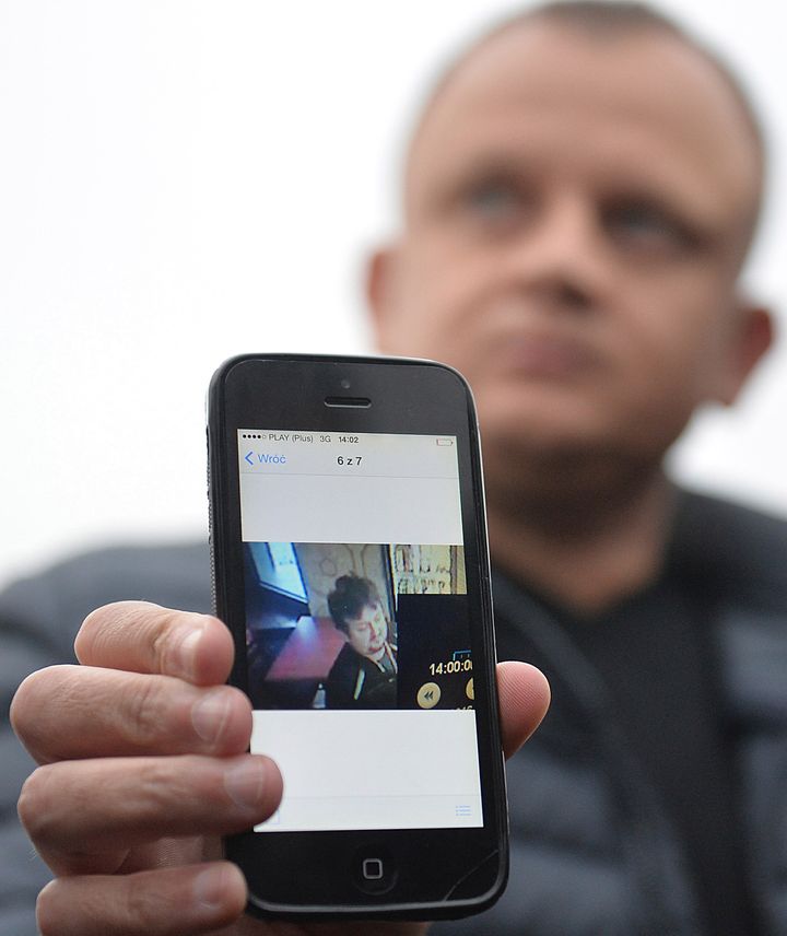 <strong>Ariel Zurawski, the owner of a Polish trucking company, shows the last photo taken of his cousin and driver, Lukasz Urban, who was apparently the first victim of the attack in Berlin on Monday</strong>