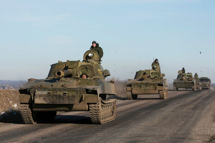 Soldiers of the separatist self-proclaimed Donetsk People's Republic army ride in mobile artillery cannons as they are pulling back from from Debaltseve, February 25, 2015.