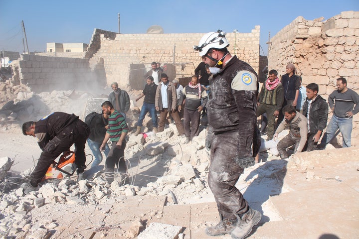 Civil defense members and citizens carry out search and rescue work in Aleppo, Syria on November 25, 2016.