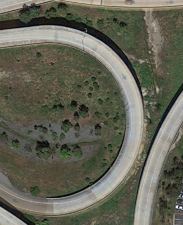 The wrecked vehicle was located in a field 30 feet below these two roadways.