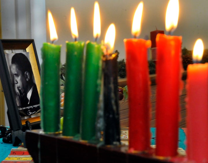 A photograph of President Obama sta beside the lit candles during the Kwanzaa celebration at the Benjamin Banneker Historical Park and Museum on Saturday, December 29, 2012 in Catonsville, Md.