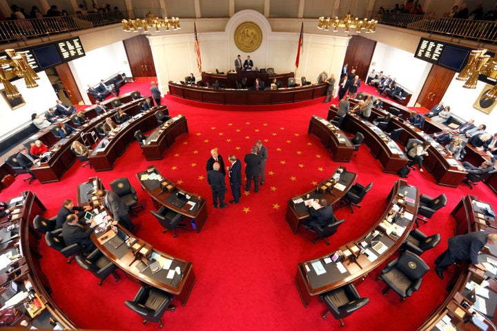 Lawmakers confer during a negotiations on the floor of North Carolina's State Senate chamber as they meet to consider repeali