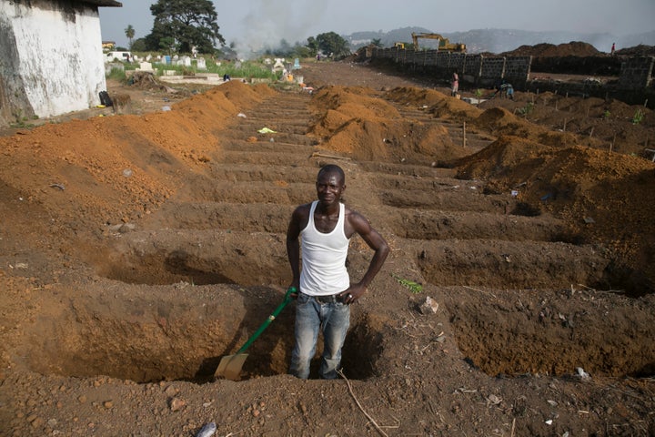 Scientists have developed an experimental Ebola vaccine after an outbreak in 2014 killed 11,000 people. Above, a grave digger prepares new graves on Dec. 21, 2014, at a cemetery in Freetown, Sierra Leone, where about 30 suspected Ebola victims were being buried per day during the epidemic.