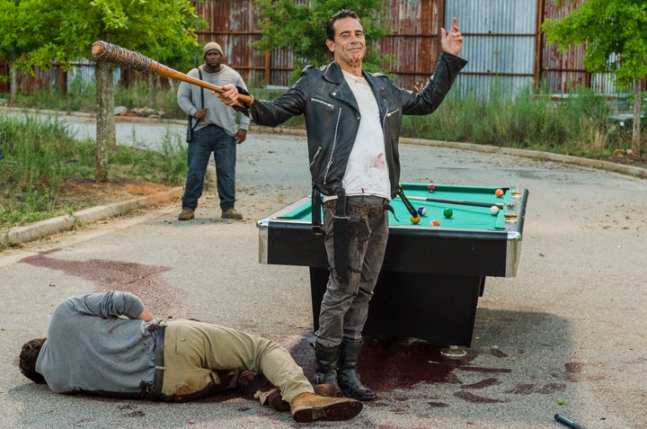 Negan finishes off a game of pool by switching to another favorite sport.