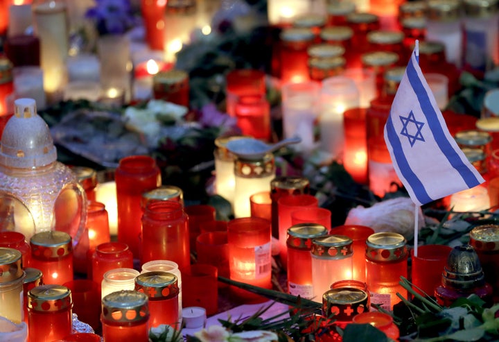 A small flag of Israel is pictured between candles and flowers after the reopening of the Christmas market at the Kaiser Wilhelm Memorial Church in Berlin, Germany.