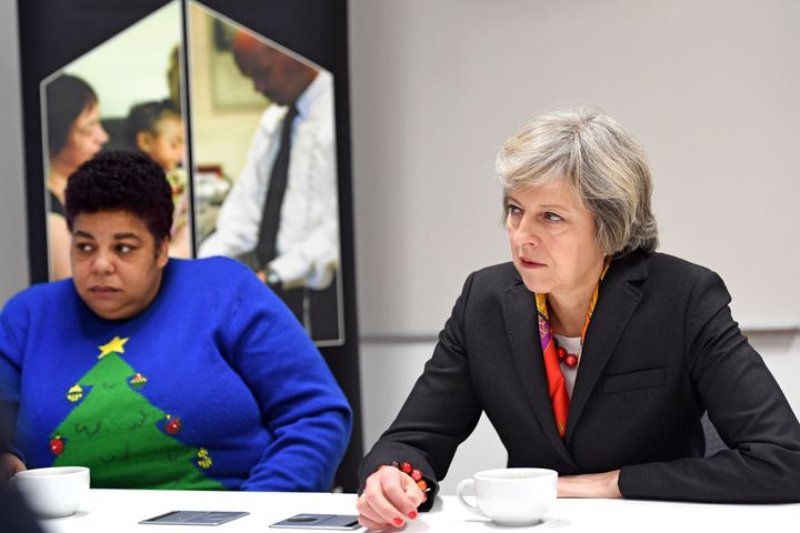 Prime Minister Theresa May (right) with Maxine Thomas, a support worker at Robertson Street Hostel during her visit to Thames Reach Employment Academy centre, South East London.